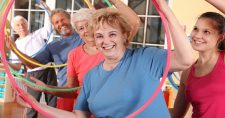Stroke Risk Factors, picture of a group of Caucasian elders with an instructor and hula-hoops