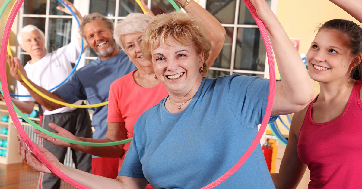 Stroke Risk Factors, picture of a group of Caucasian elders with an instructor and hula-hoops