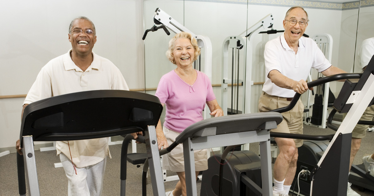 Is Sitting Too Much Bad for Your Brain? Picture of an elderly black male, an elderly caucasian female and an elderly caucasian male all walking on tread mills.